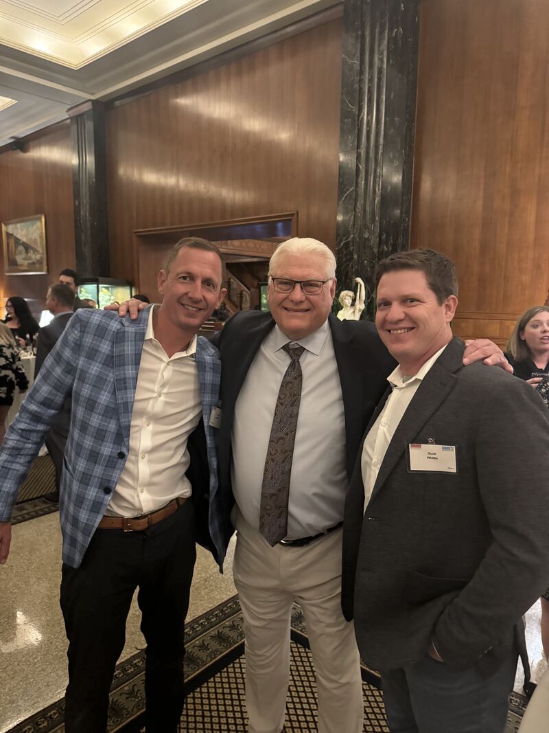 Fifth-generation owner Jake Whittle and Scott Whittle of Niehaus Building Services standing with former St. Louis Rams coach Mike Martz at a regional trade association foundation anniversary event, highlighting the company's long-standing industry relationships and St. Louis community presence.