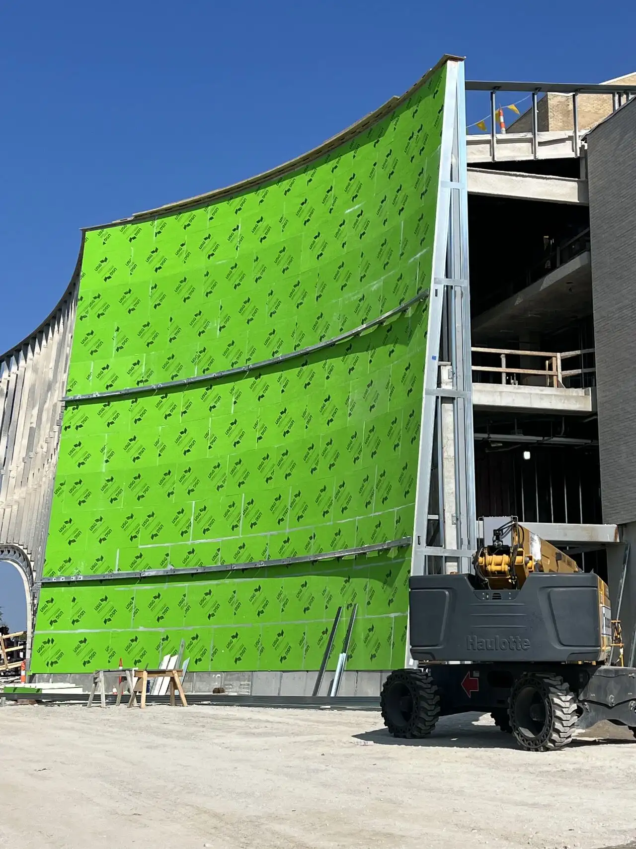 A massive curved exterior commercial wall assembly at Powell Hall in St. Louis featuring green Securock ExoAir 430 gypsum panels with an integrated factory-applied synthetic air and water barrier installed by Niehaus Building Services.