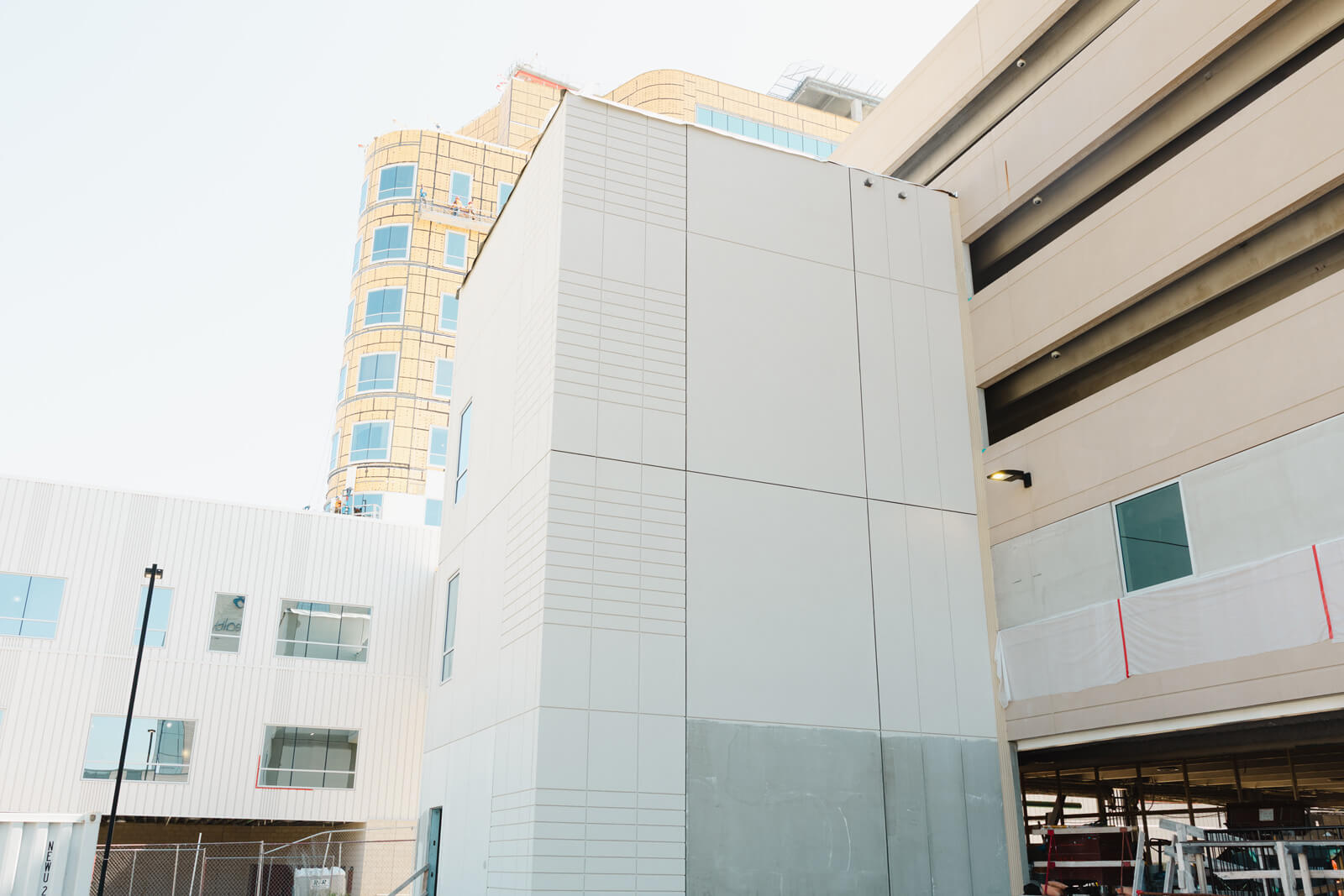 Exterior view of a multi-story commercial structure featuring smooth grey EIFS wall cladding and sheathing.